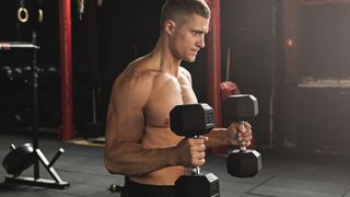 Man performs the hammer curl biceps exercise with dumbbells