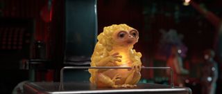 A yellow glowing alien baby from Atomic Heart 2.