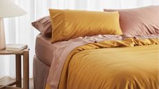 best bed sheets pink and yellow pillows styled on bed 