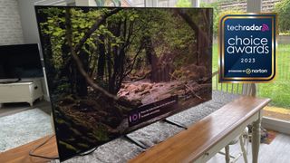 Samsung S90C on a table, next to a sign saying TechRadar Choice Awards 2023