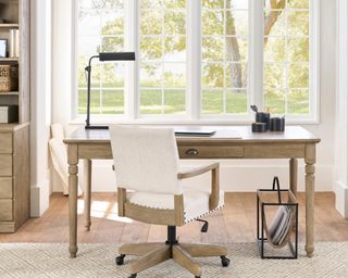 Wooden desk with white chair and desk lamp
