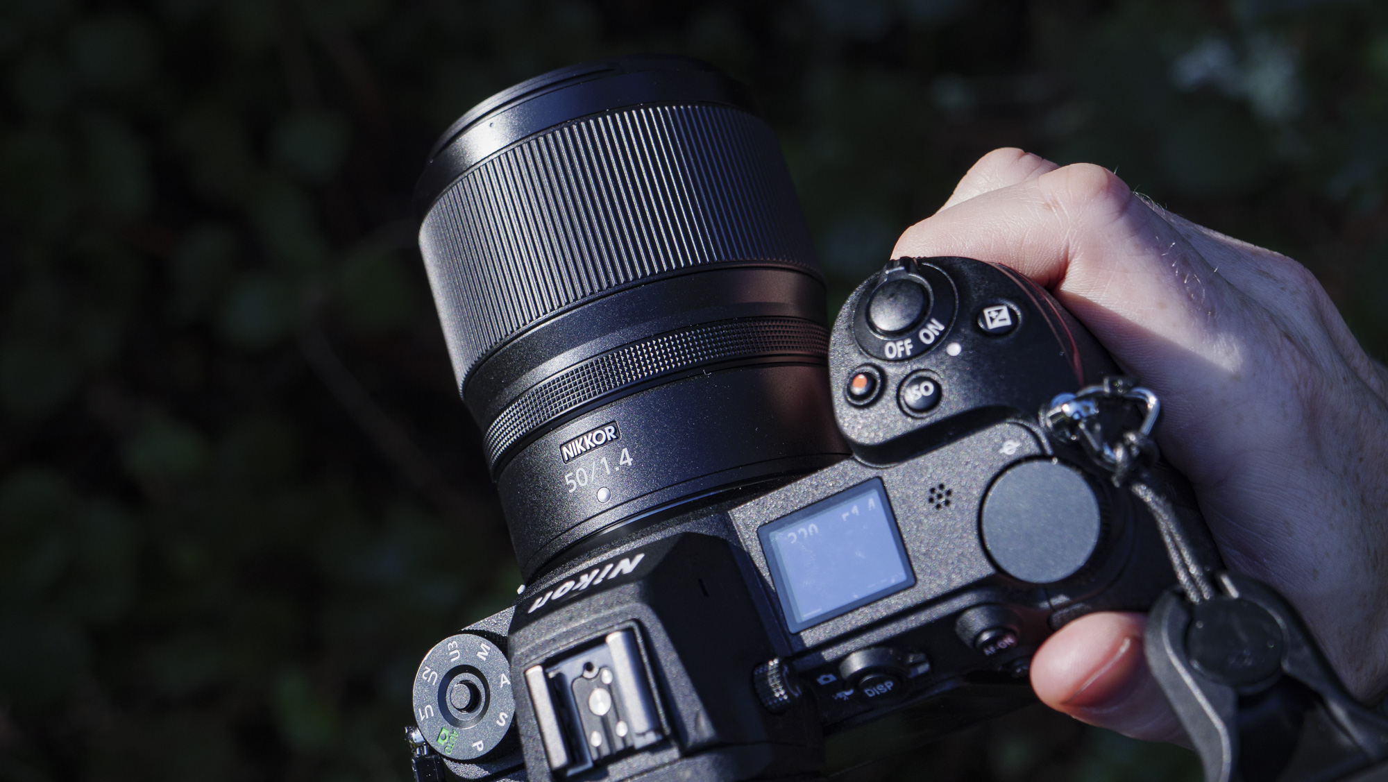 Nikon Z 50mm f/1.4 lens attached to a Nikon Z6 II, in the hand