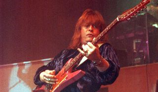 Rick Derringer wields his B.C. Rich Stealth guitar onstage in 1991