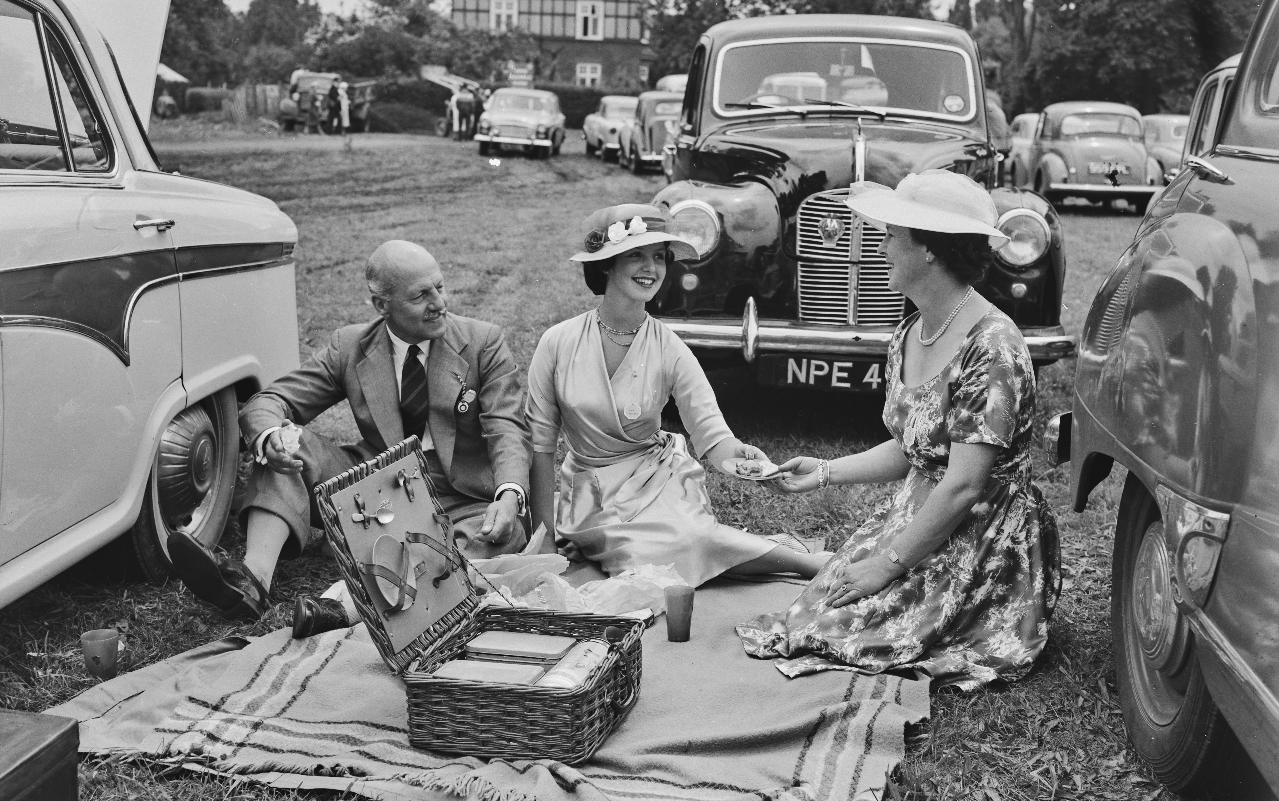 Lieutenant Colonel and Mrs HHK Rowe, with their daughter Susan, having a picnic during the Henley Royal Regatta in Henley-on-Thames, Oxfordshire, July 1958. 