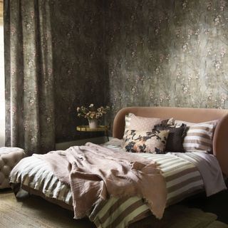 Bedroom with double bed in with floral wallpaper