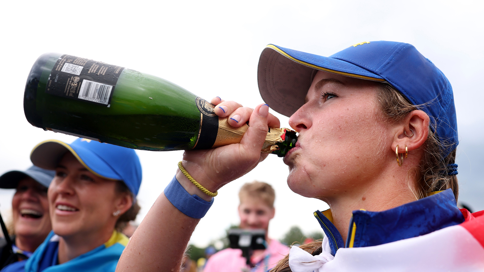 Mimi Rhodes drinks champagne