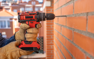 Drilling into red brick