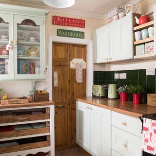 kitchen with white cabinet having wooden worktop
