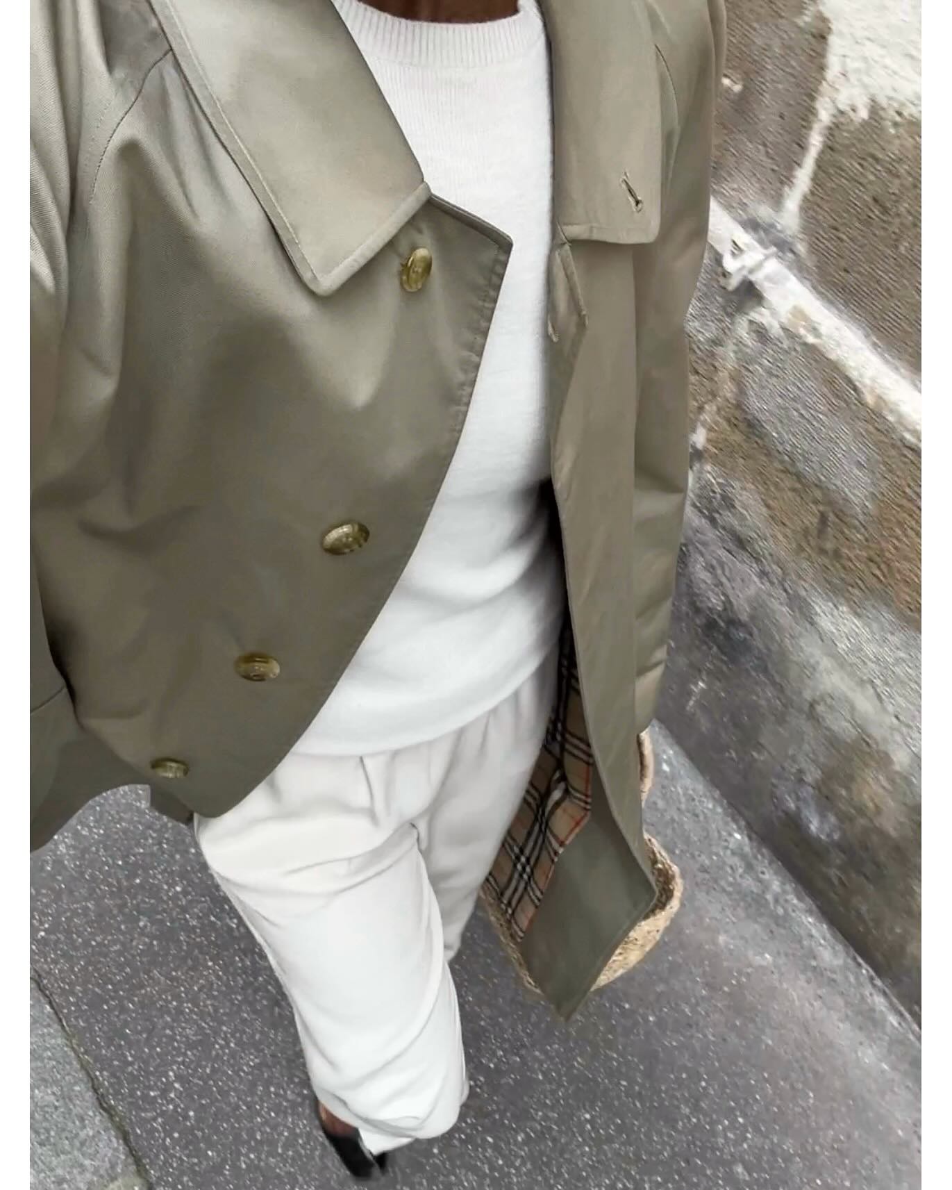 woman wearing a trench coat and cream set
