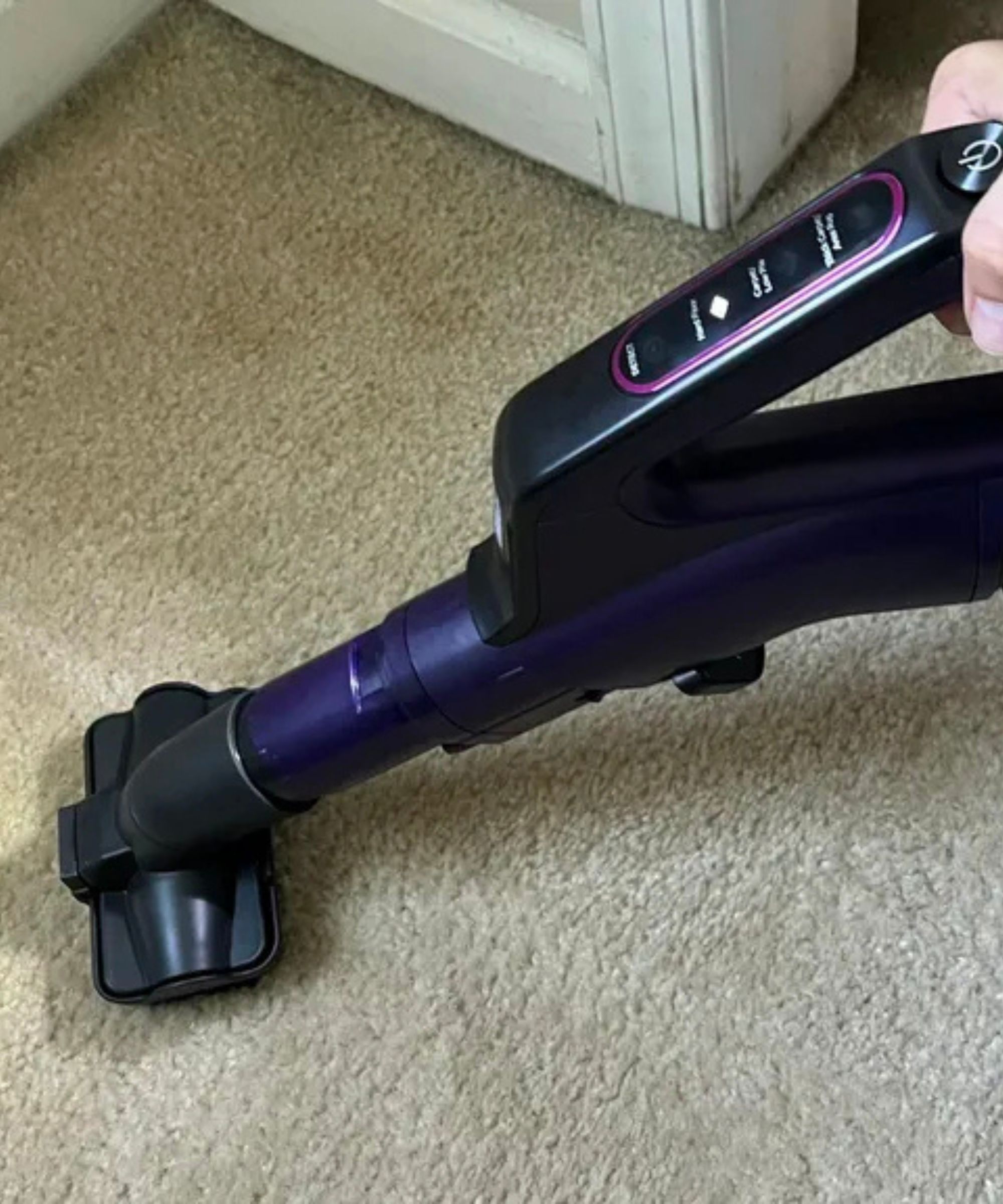 Shark POWERDETECT Upright Vacuum multi-pet tool in use on cream carpet with LED lights illuminating the floor, in James Holland's home.