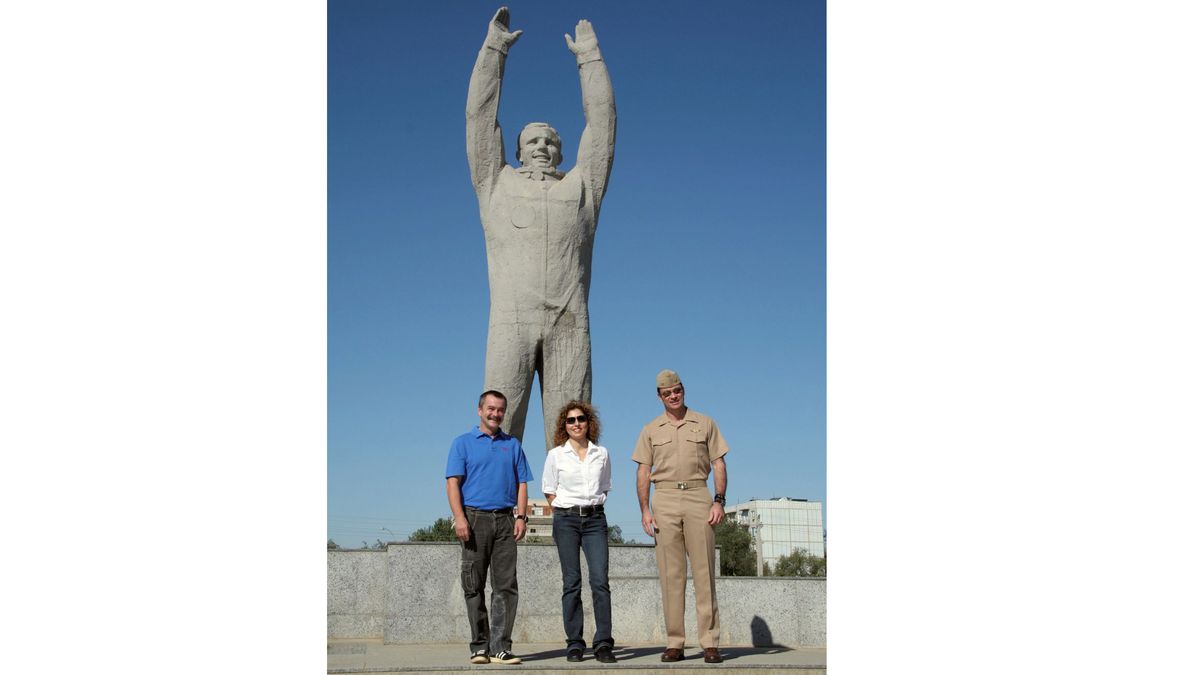 A larger-than-life statue of cosmonaut Yuri Gagarin with his arms stretched toward the heavens stands at Baikonur Cosmodrome in Kazakhstan, the launch site of his historic April 12, 1961 spaceflight, making him the first human in space. Russian cosmonaut Mikhail Tyurin (left), NASA astronaut Michael Lopez-Alegria (right) and space tourist Anousheh Ansari pose with Gagarin's statue on Sept. 13, 2006 while training for a launch toward the International Space Station.
