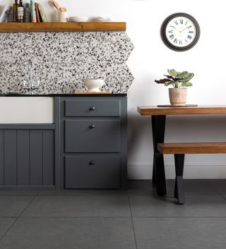 kitchen room with grey tiled flooring and wooden table with benches