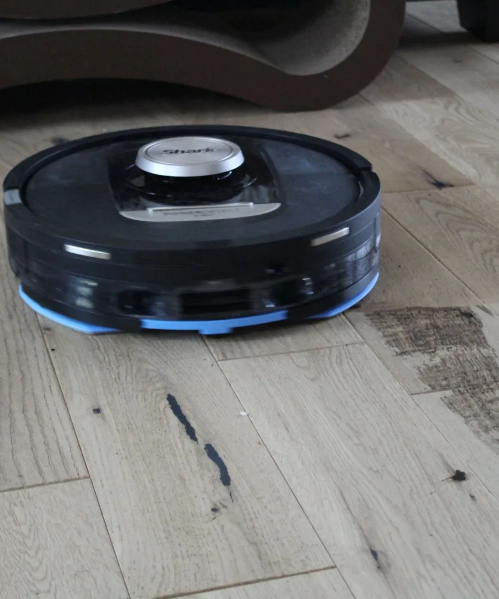 Shark PowerDetect 2-in-1 Robot Vacuum mopping hardwood floor in Camryn Rabideau's home, leaving streaks through dirt on floor.