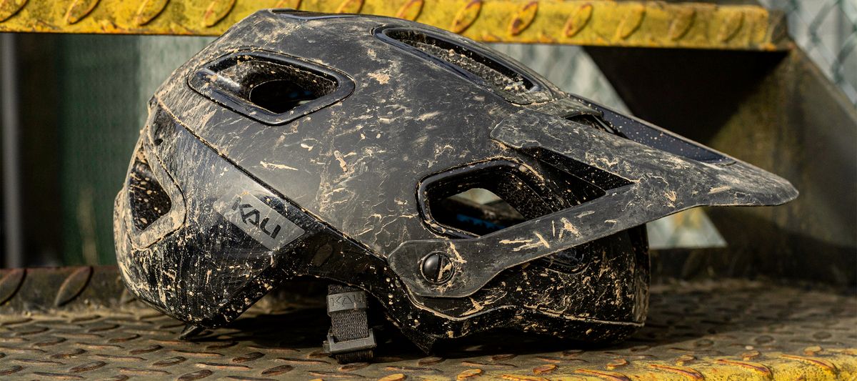 A muddy Kali Cascade MTB helmet