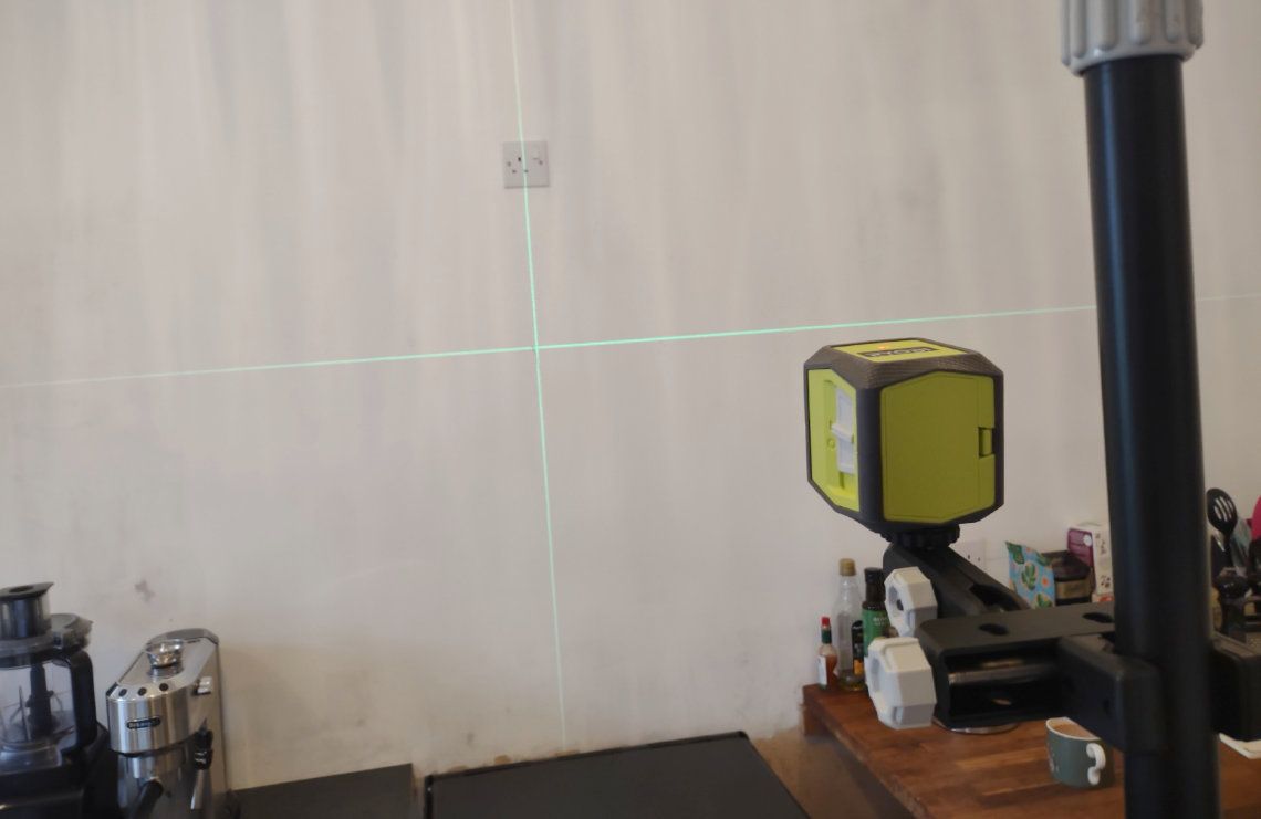 A laser tool used to measure distance on a wall