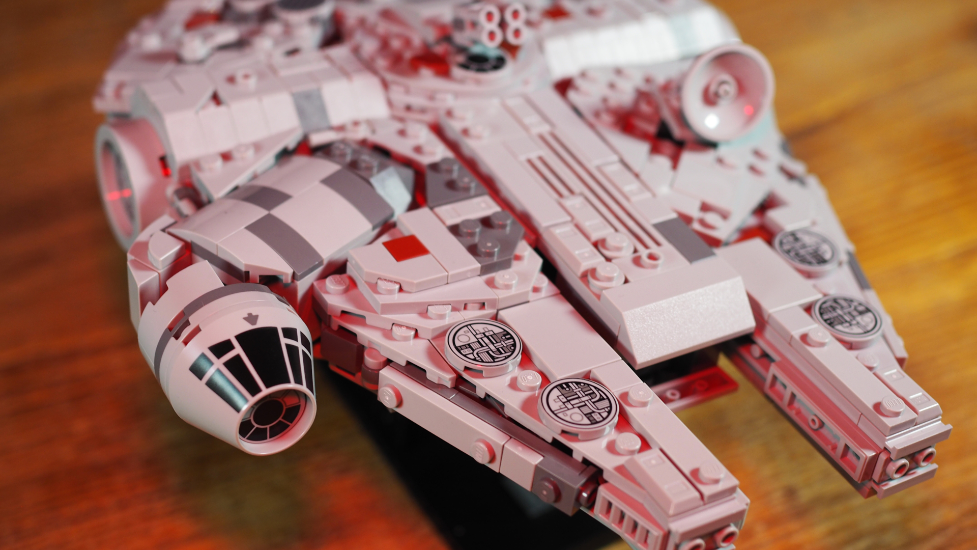 Lego Millennium Falcon set laid out on a wooden surface