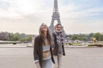 Happy mature couple in front of Eiffel Tower, Paris, France.