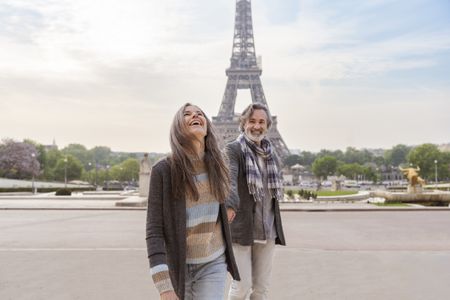 Happy mature couple in front of Eiffel Tower, Paris, France.