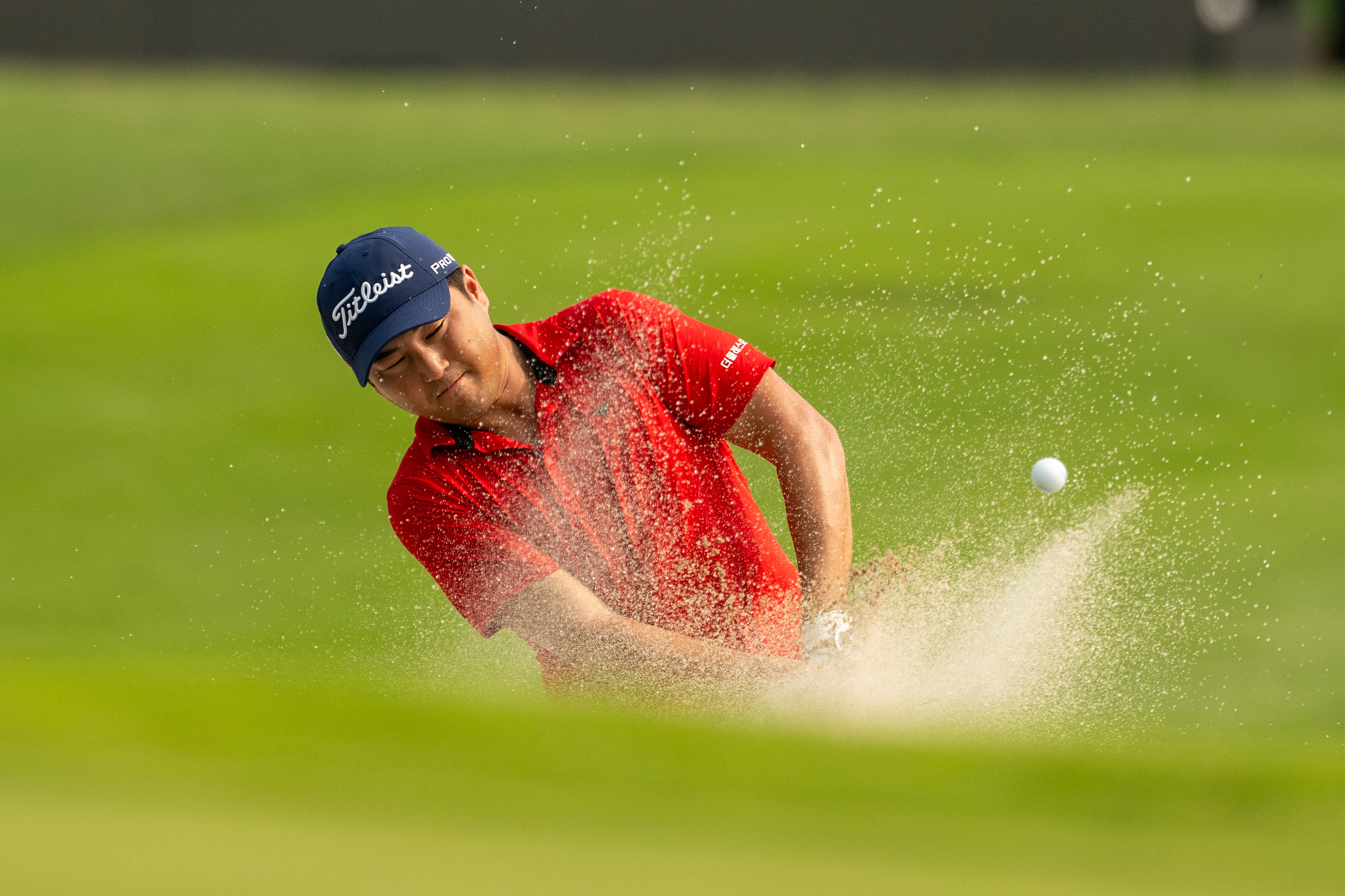 Richard T Lee hits a bunker shot