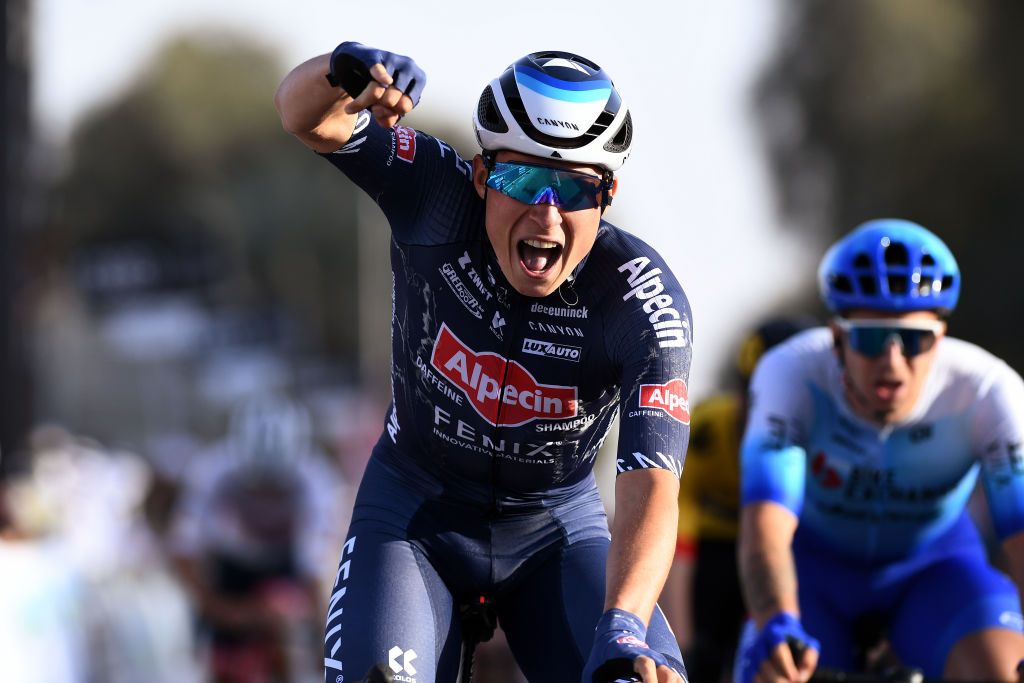 MADINAT ZAYED UNITED ARAB EMIRATES FEBRUARY 20 Jasper Philipsen of Belgium and Team AlpecinFenix celebrates at finish line as stage winner ahead of Dylan Groenewegen of Netherlands and Team Bikeexchange Jayco during the 4th UAE Tour 2022 Stage 1 a 184km stage from Madinat Zayed to Madinat Zayed UAETour WorldTour on February 20 2022 in Madinat Zayed United Arab Emirates Photo by Tim de WaeleGetty Images