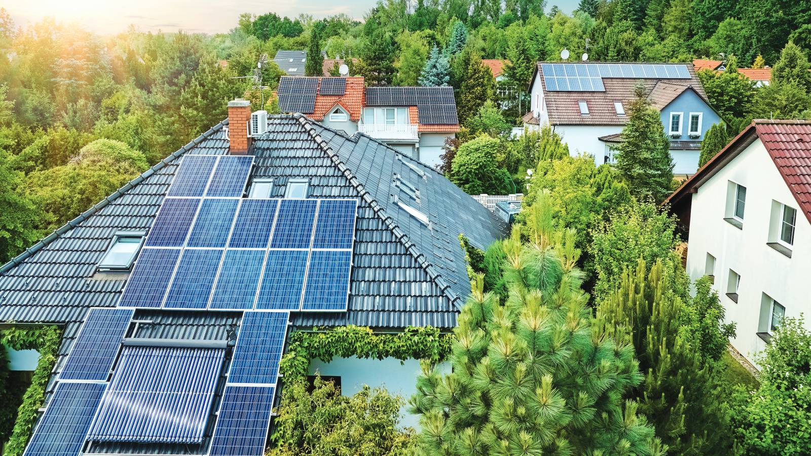 view of houses from above with solar panels on one roof