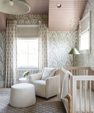Studio McGee nursery for Margot with crib, armchair and patterned wallpaper