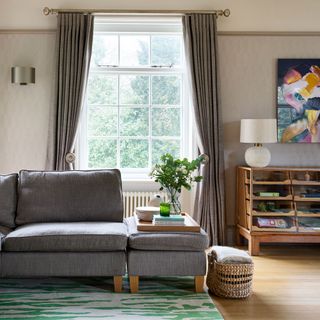 sitting area with L-shaped sofa and vintage sideboard