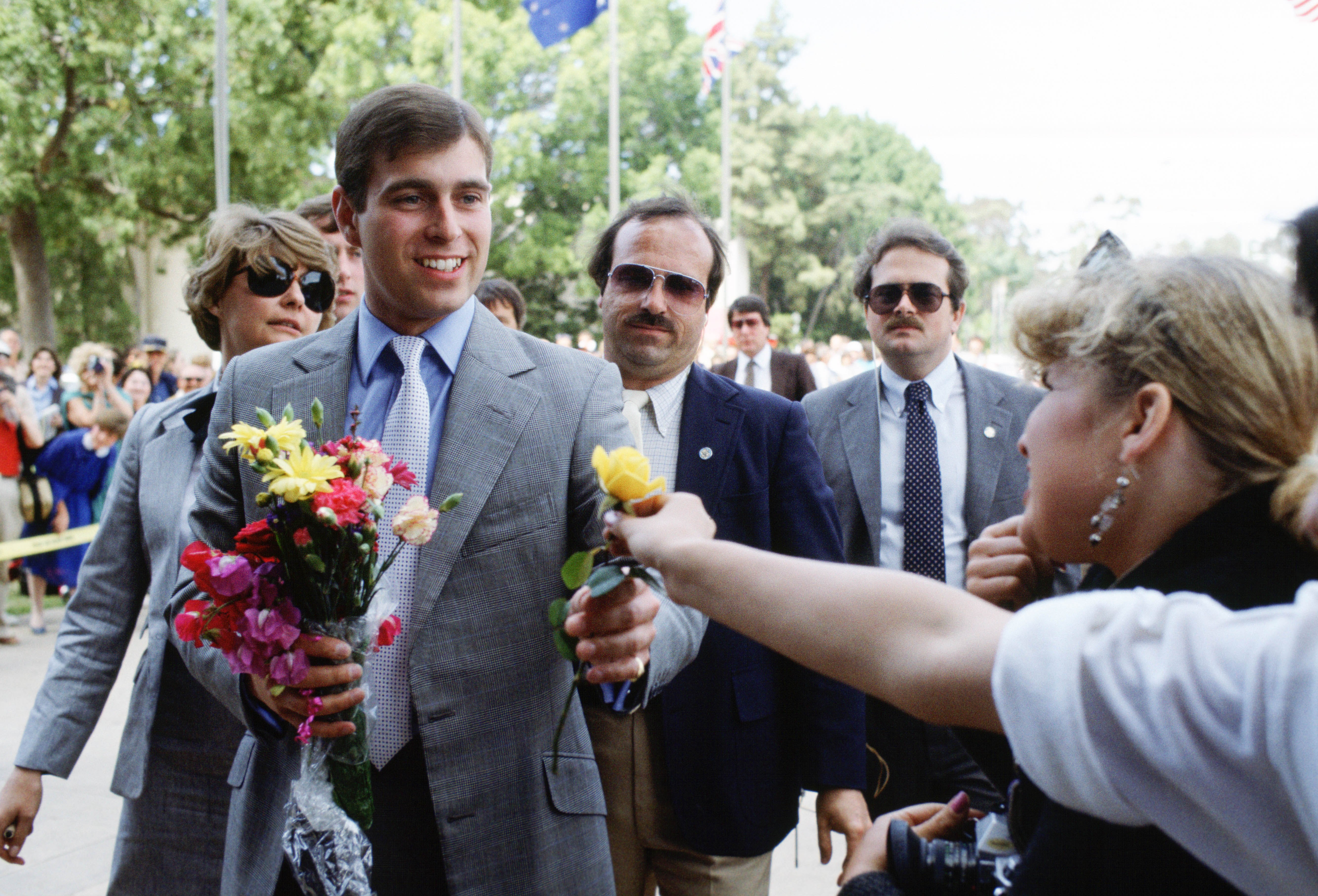 Prince Andrew taking flowers from a fan in 1984