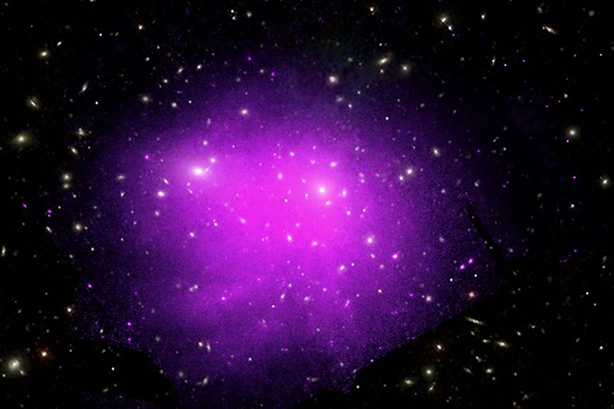  An X-ray image of the Coma galaxy cluster shows the hot gas glowing as the purple and pink colors.