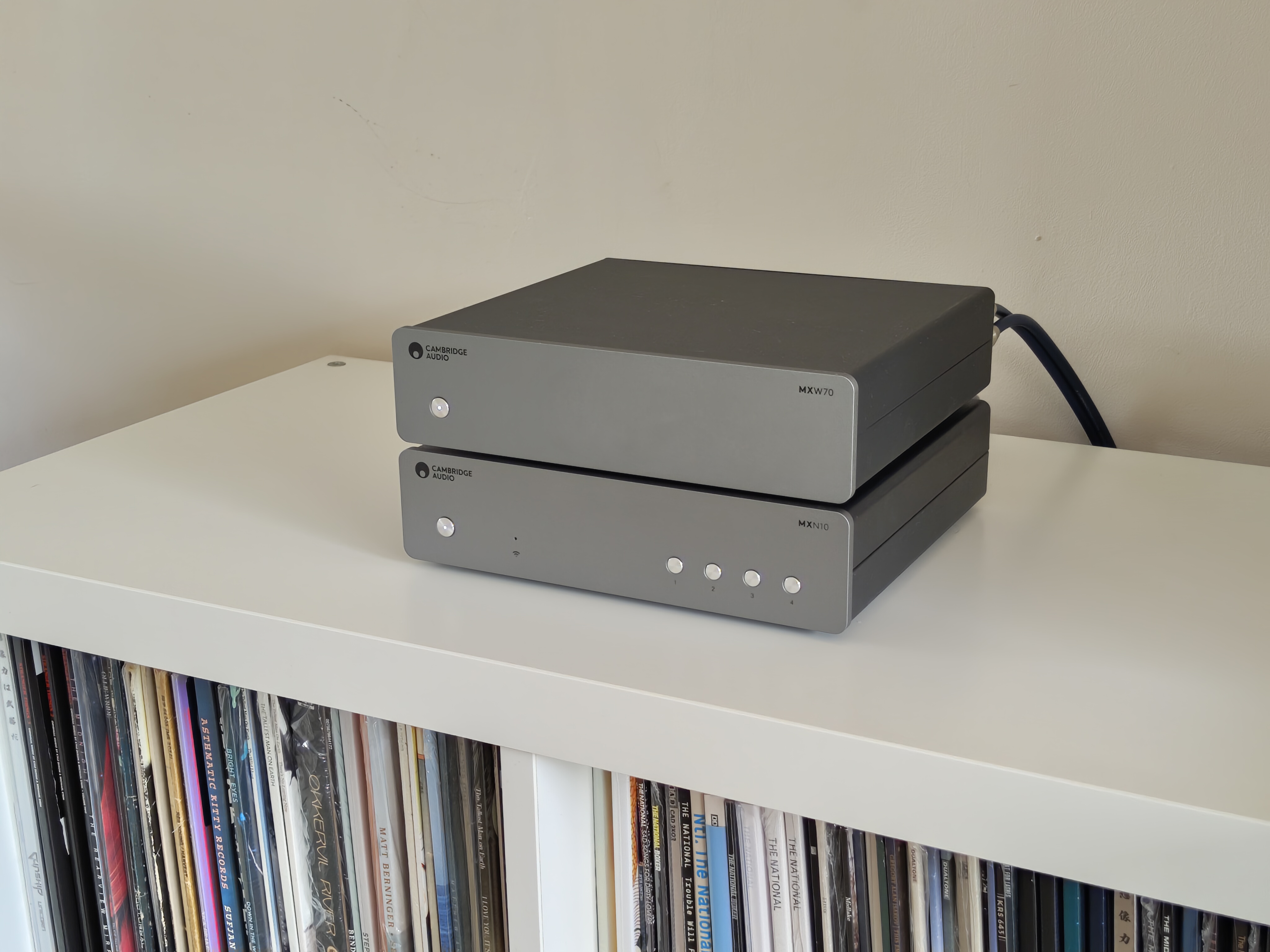Cambridge Audio MXW70 power amp on book shelf with streamer