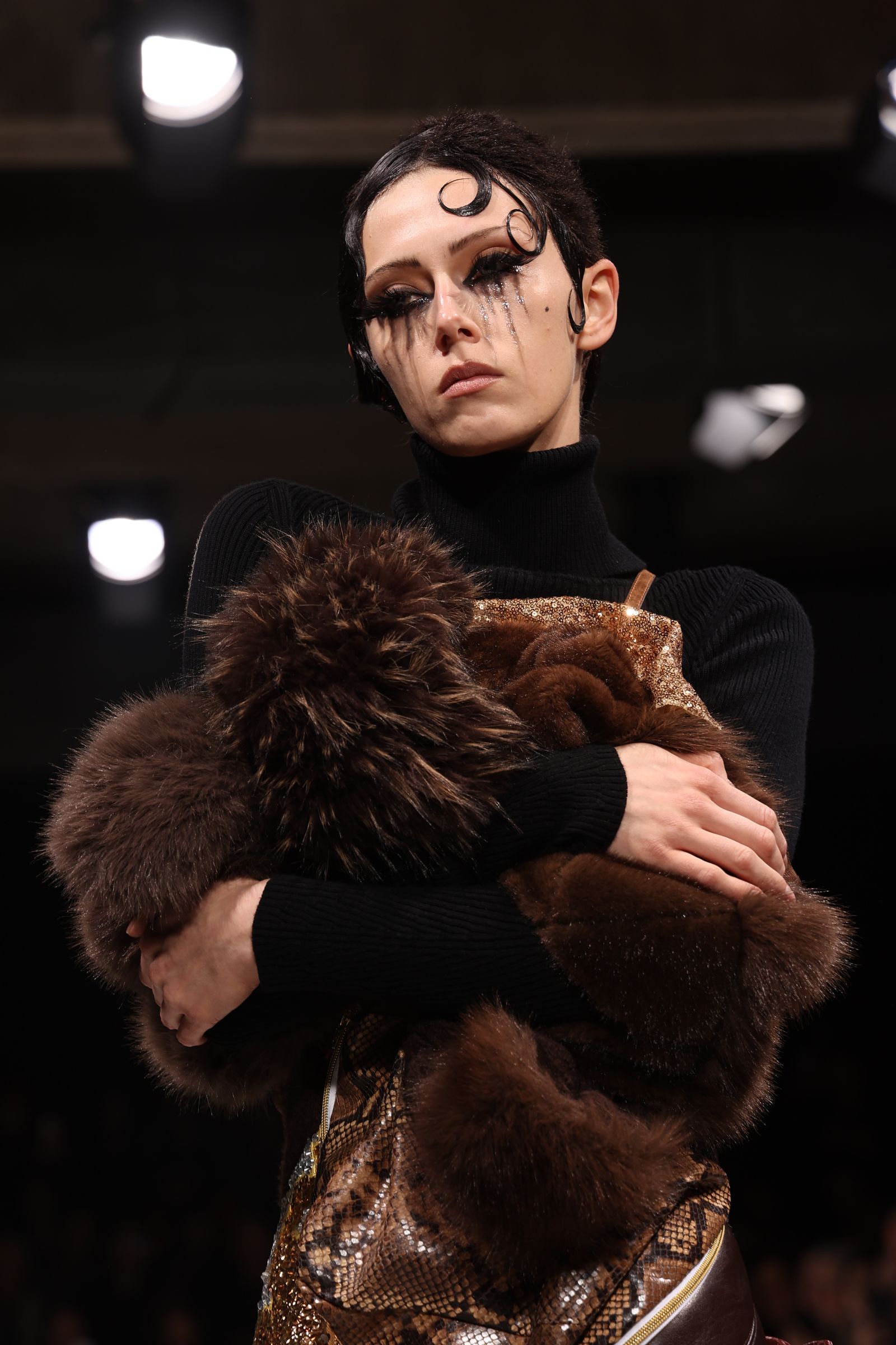 Model with streaming black eye makeup and finger-wave hair at Junya Watanabe autumn 2026