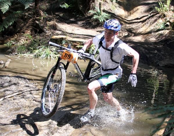 Eventuall winner Garth Weinberg runs across a stream.