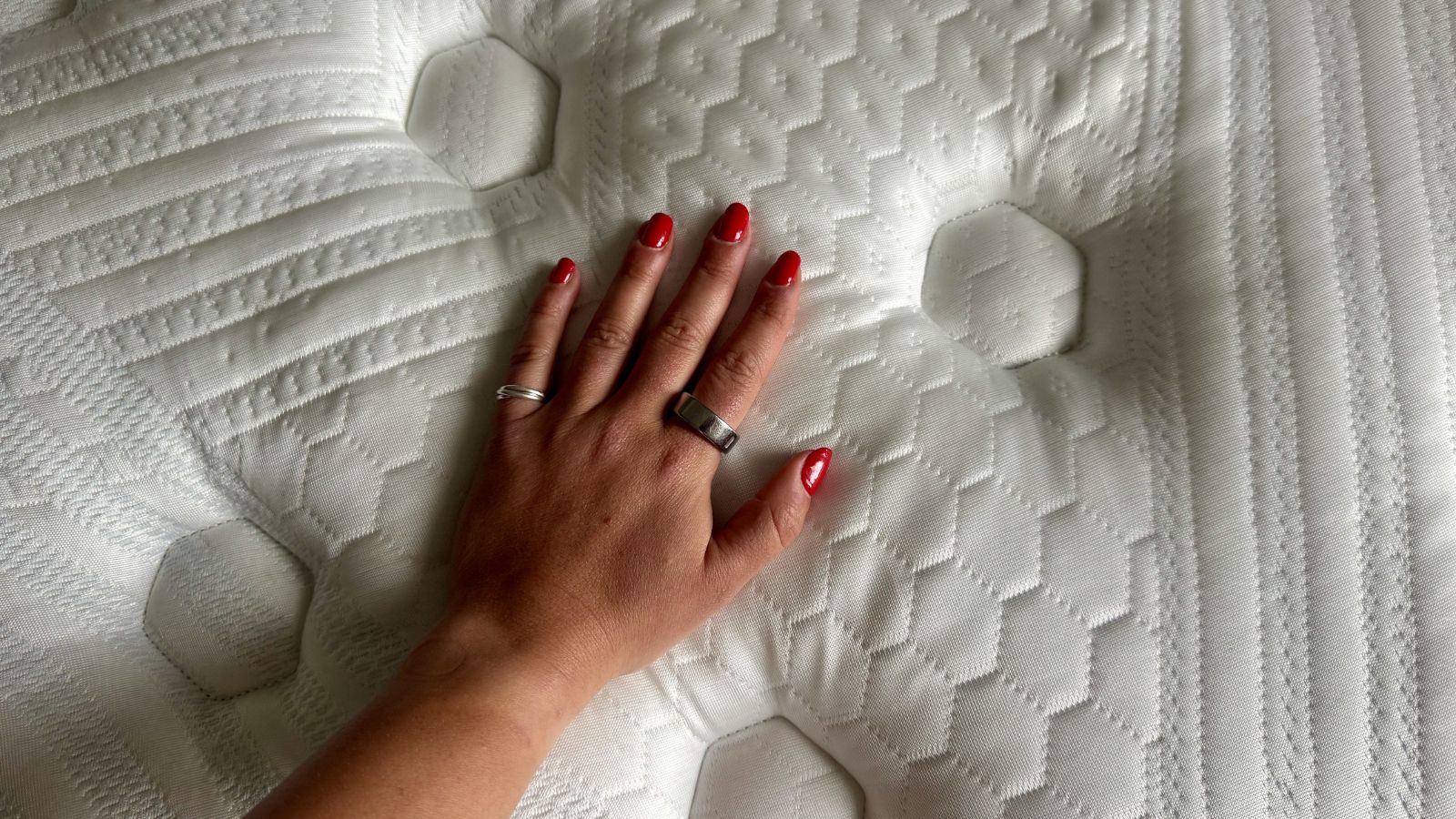 Our mattress reviewer carrying out thermal tests on the Brooklyn Bedding Thermobalance LX Elite
