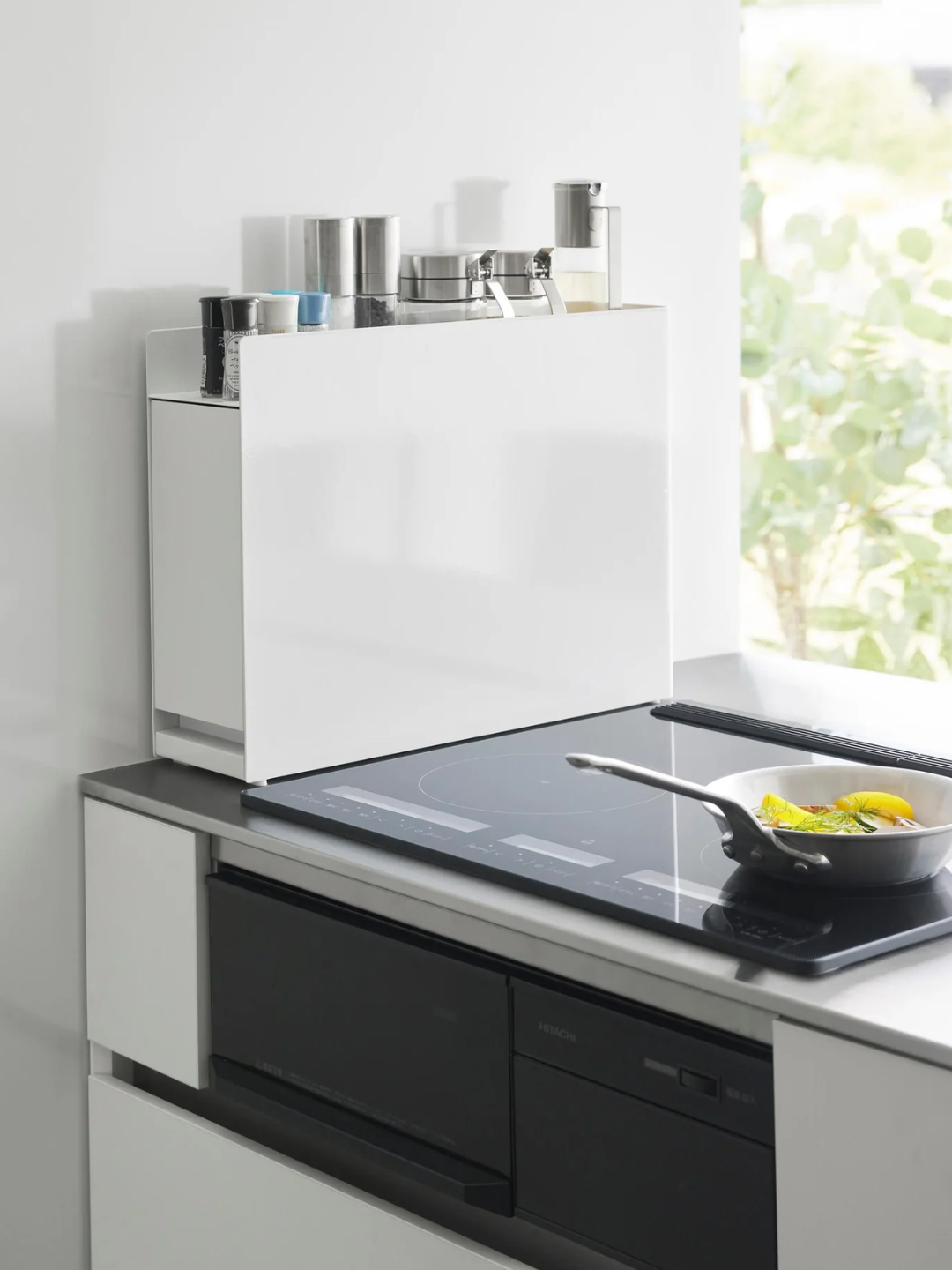 A white extendable kitchen storage shelf tower from Yamazaki