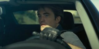 Robert Pattinson driving a car in Tenet