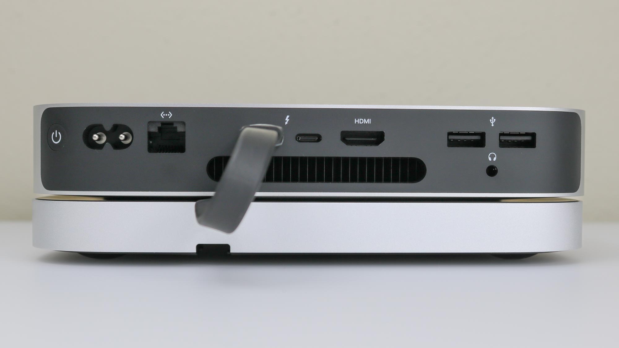 A rear shot of a Mac mini M2 with a Satechi Mac Mini Hub underneath it