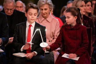 Prince George lighting a candle in church from Princess Charlotte in December 2024