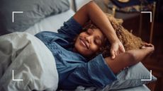 Woman lying down relaxed in bed with arms raised after learning how to sleep better