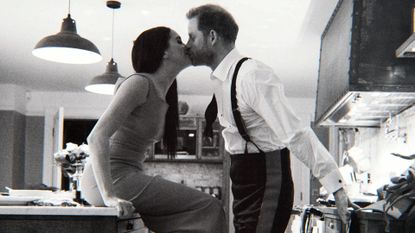 Prince Harry and Meghan Markle kissing in a still from their Netflix documentary series.