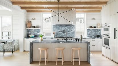 Kitchen with wooden stools by kitchen island and wooden ceiling