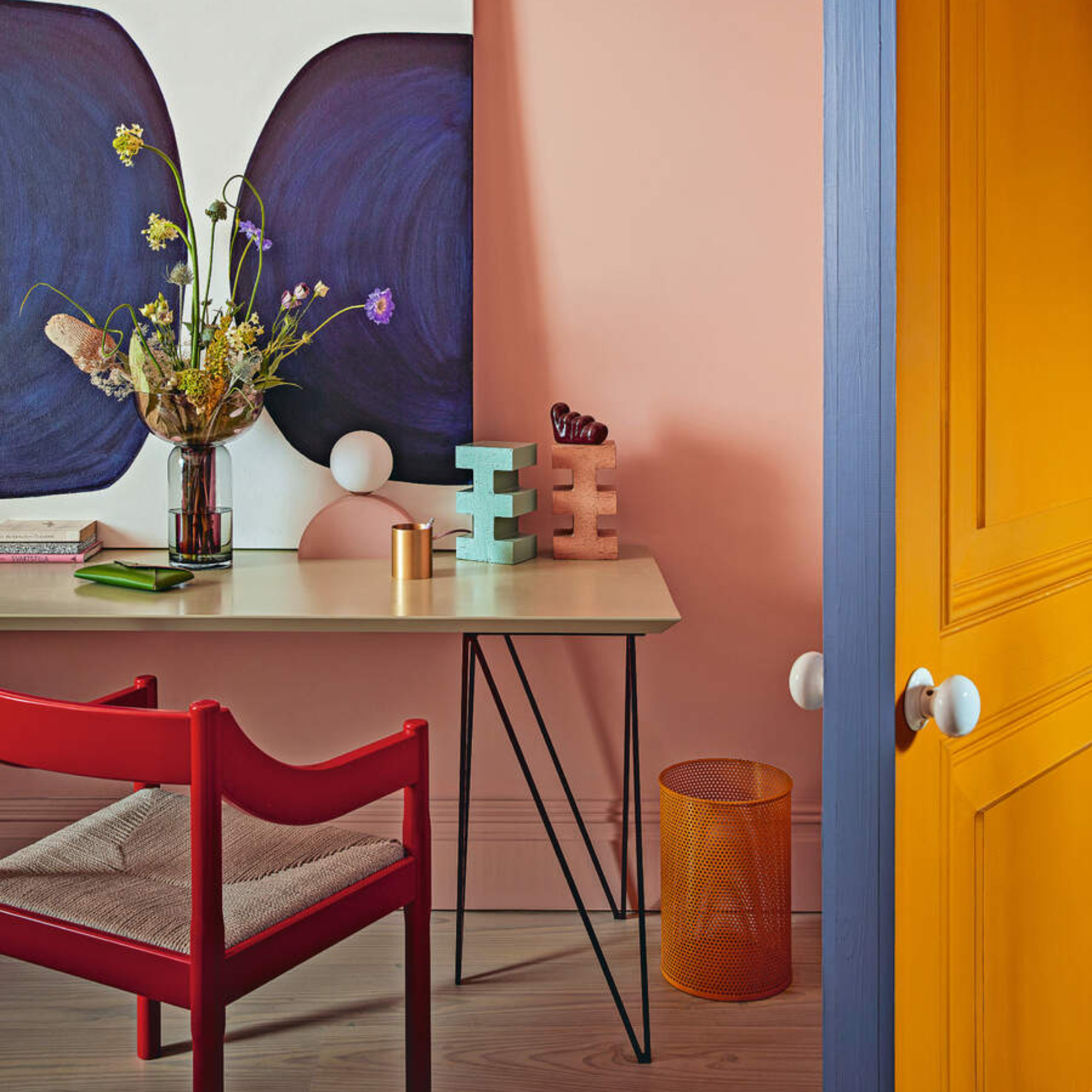 Pink and red office with a splash of blue on the door.