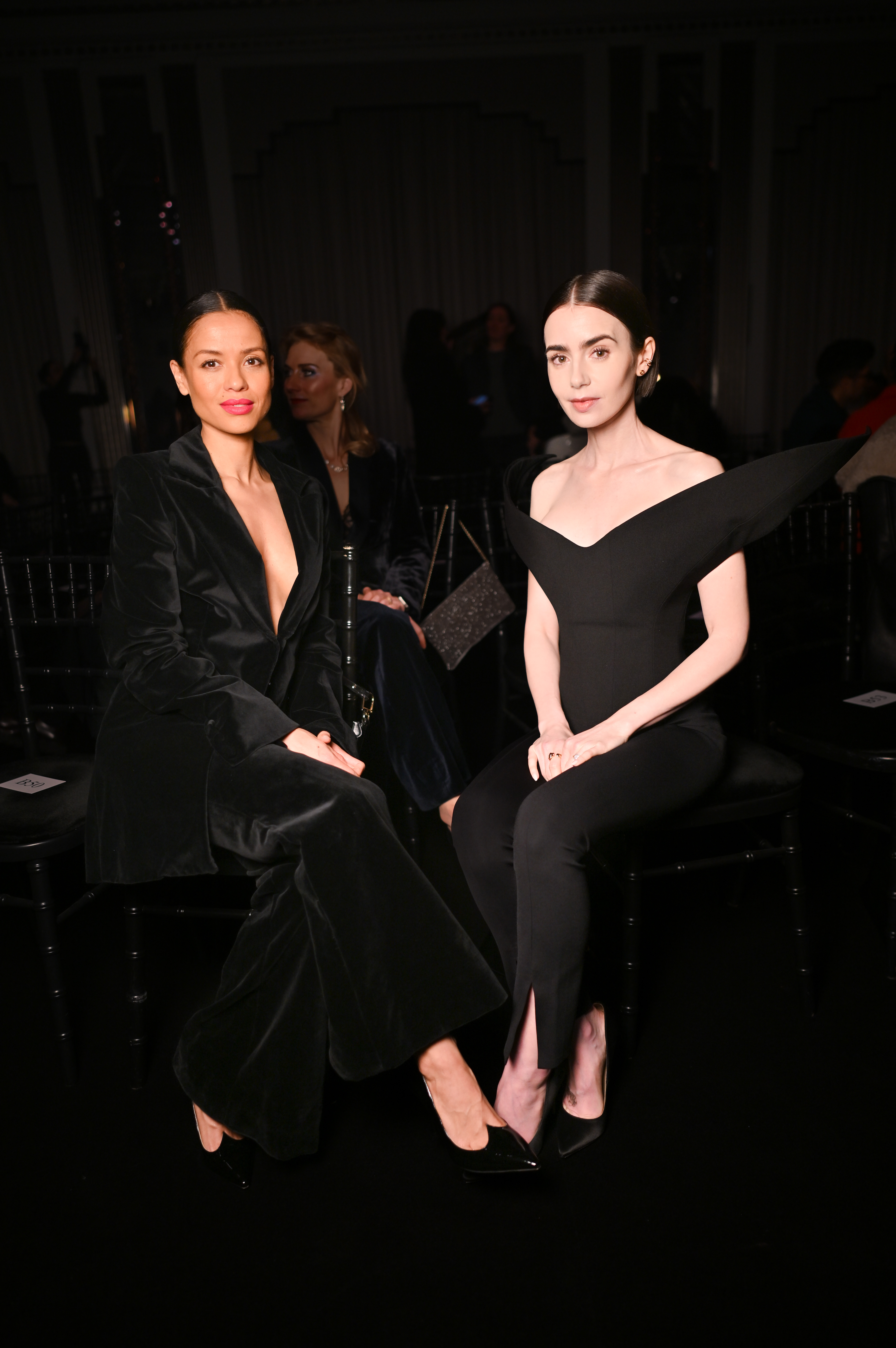 Gugu Mbatha-Raw and Lily Collins attend the Harris Reed aw26 show during london fashion week