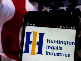 Huntington Ingalls Industries logo seen displayed on a smartphone with American flag in the background