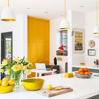 room with white counter and yellow pantry doors