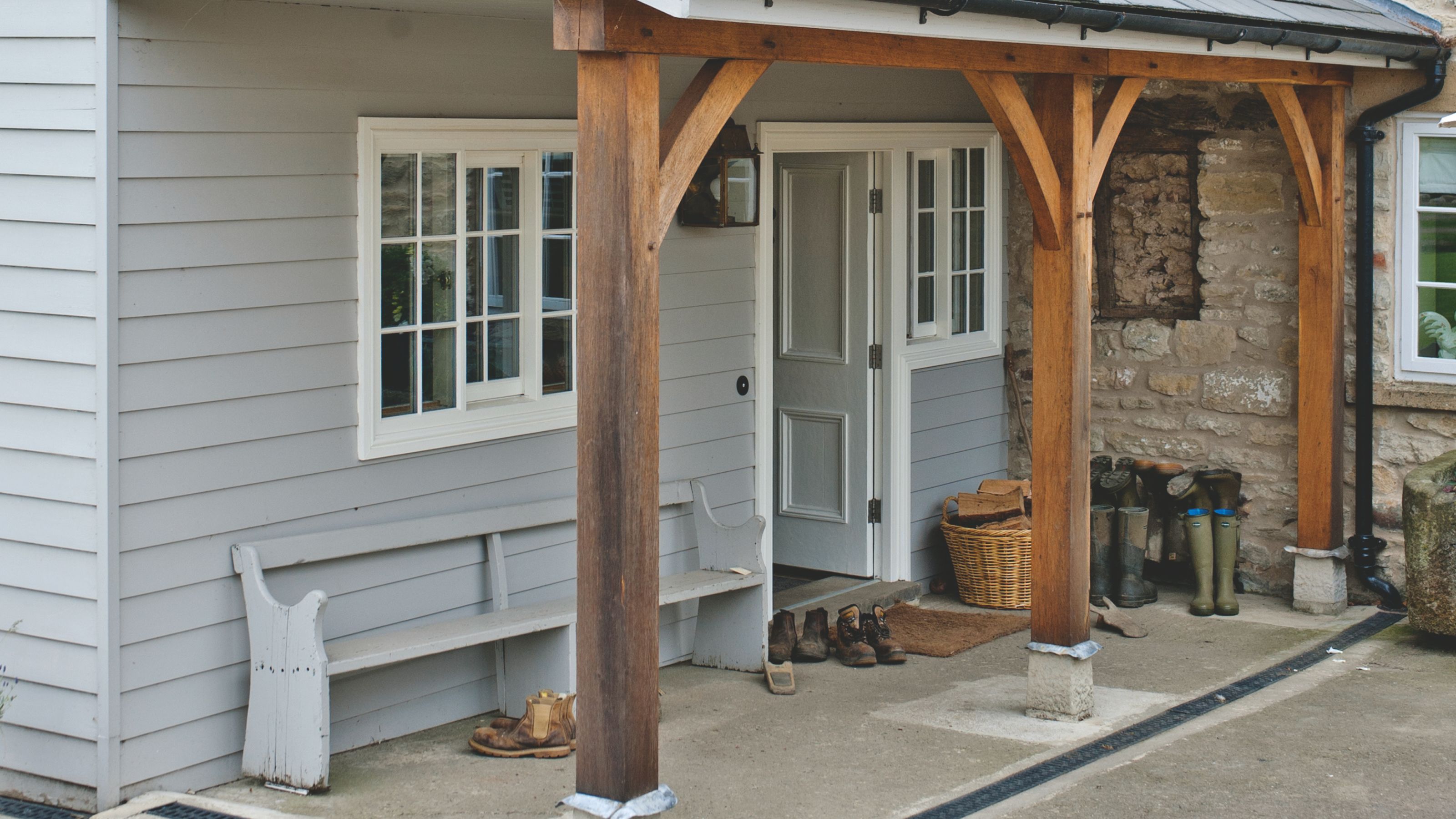 Annexe with porch and outdoor bench added to stone home
