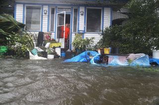 People in a neighborhood in St. Augustine, Florida, look out at the flooded street in front of their home as Hurricane Matthew passes through on Oct. 7, 2016.