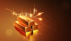 Gold bar in front of a price chart