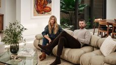 kevin love and kate love on a sofa in their living room