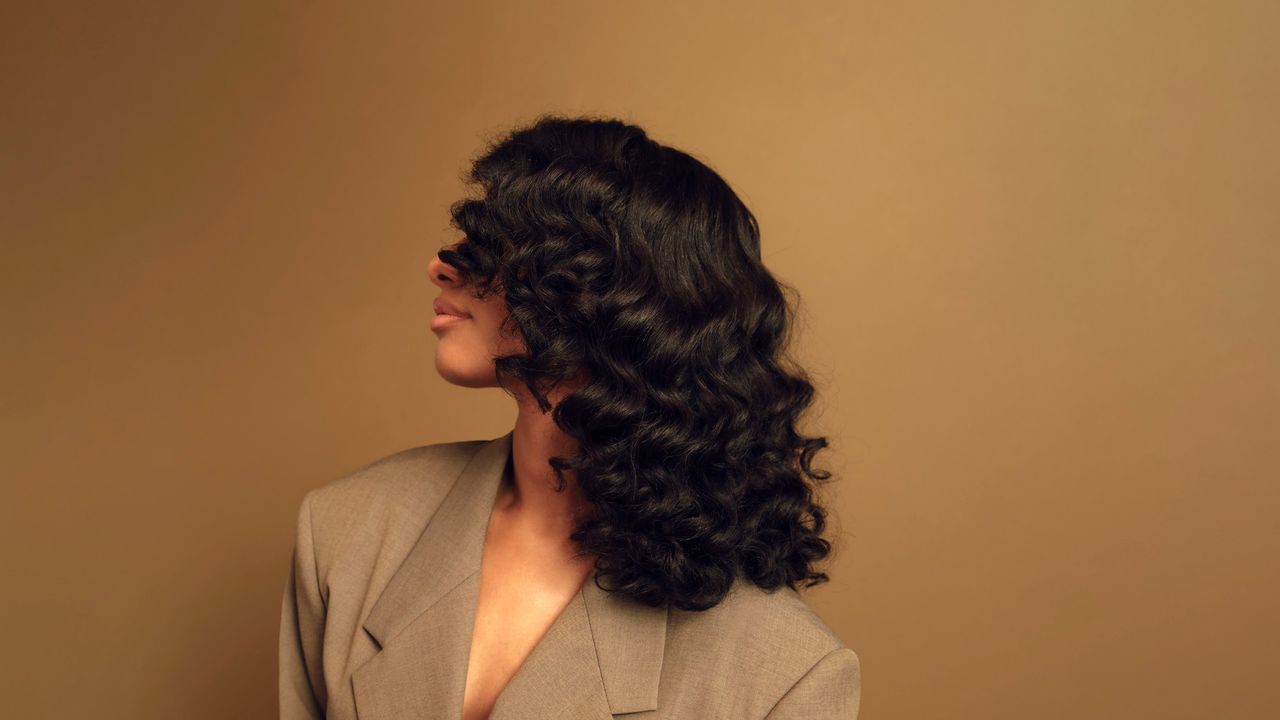 side profile of a model with curly hair