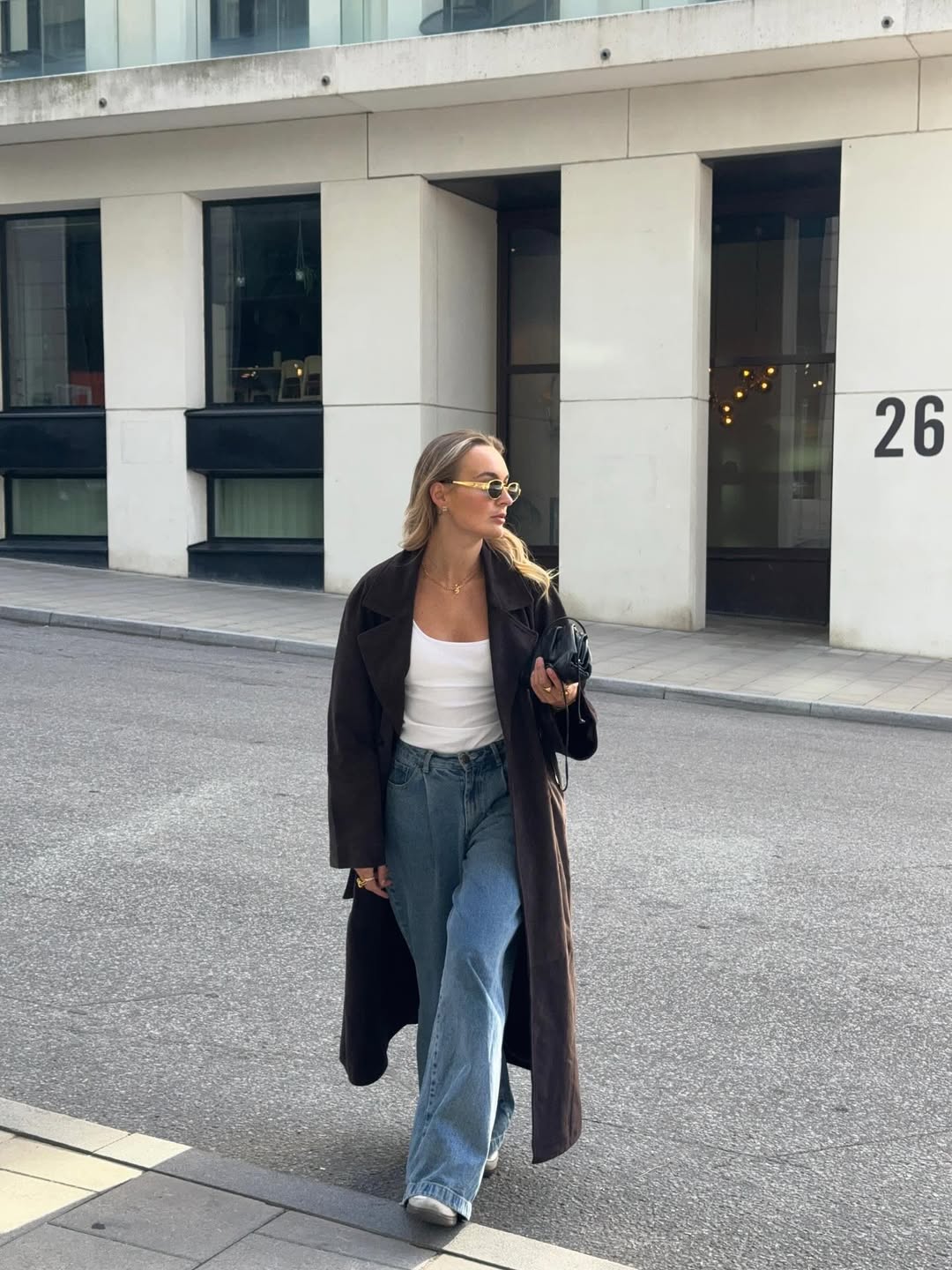 Influencer Fredrica Eriksson wearing a suede trench coat and wide leg jeans.